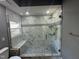 Luxurious glass shower with mosaic accent tile, built-in bench, and stylish fixtures at 9013 Tenderfoot Trl, Raleigh, NC 27615