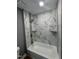 Beautifully tiled walk-in shower with two built-in shelving units and gold hardware at 9013 Tenderfoot Trl, Raleigh, NC 27615