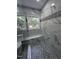 Close up on the shower. The glass shower features marble-style accent tile and a built-in bench at 9013 Tenderfoot Trl, Raleigh, NC 27615