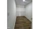 Bright walk-in closet with wood floor and wire shelving units for optimized storage solutions at 9013 Tenderfoot Trl, Raleigh, NC 27615