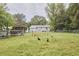 Spacious backyard with a wooden pergola, partial fencing, and a well-maintained lawn at 909 Goodwin Rd, Durham, NC 27712