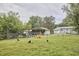 Large backyard with play equipment, garden area, lawn space, and perimeter fencing at 909 Goodwin Rd, Durham, NC 27712