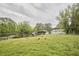Expansive fenced backyard featuring a play set, garden area, and a large grass area at 909 Goodwin Rd, Durham, NC 27712