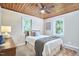 Cozy bedroom with wood ceiling, natural light, carpeted floors, and neutral walls at 909 Goodwin Rd, Durham, NC 27712