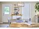 Charming dining area with modern lighting, a wooden table, and easy access to the backyard at 909 Goodwin Rd, Durham, NC 27712