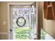 Welcoming entryway with a glass door, wreath accent, and a view to the landscaped yard at 909 Goodwin Rd, Durham, NC 27712