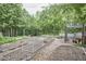 Large fenced garden with rows of vegetables, small plants and a chicken coop at 909 Goodwin Rd, Durham, NC 27712