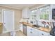 Kitchen with white cabinets and stainless steel appliances, tile floors and butcher block countertops at 909 Goodwin Rd, Durham, NC 27712