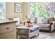 Inviting living room filled with natural light, featuring cozy sofas and a decorative coffee table at 909 Goodwin Rd, Durham, NC 27712