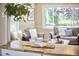 Bright living room with large windows, comfortable seating, and stylish decor at 909 Goodwin Rd, Durham, NC 27712