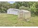 Spacious yard with white outbuilding and a greenhouse, perfect for gardening enthusiasts at 909 Goodwin Rd, Durham, NC 27712