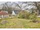 View of the backyard with lush greenery, trees and other homes in the background at 913 Washington St, Durham, NC 27701