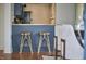 Home bar seating with wood countertop, blue cabinetry, and stylish gold bar stools at 913 Washington St, Durham, NC 27701