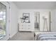 A comfortable bedroom displays a modern dresser, door to the backyard, and neutral colors at 913 Washington St, Durham, NC 27701