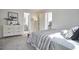 A bright bedroom features a dresser, walk-in closet, and attached bathroom with modern decor at 913 Washington St, Durham, NC 27701