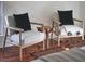 Bedroom featuring two wooden chairs with black pillows and a side table on wood floors with natural light at 913 Washington St, Durham, NC 27701