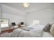 Bright and airy bedroom showcasing natural light, two wooden chairs, and a cozy bed with striped bedding at 913 Washington St, Durham, NC 27701