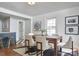 An inviting dining area with modern decor, a dark wood table, and a view of the kitchen at 913 Washington St, Durham, NC 27701