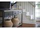 The entryway features a console table, woven baskets, and a staircase with white banister at 913 Washington St, Durham, NC 27701