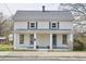 Charming two-story home featuring a covered front porch, gray shutters, and a well-maintained lawn at 913 Washington St, Durham, NC 27701