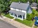 Aerial view shows the home's traditional architecture, large porch, landscaping, and sidewalk at 913 Washington St, Durham, NC 27701