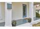 A close-up of the front porch showing flowerpots, a mailbox, a front door, and brick steps at 913 Washington St, Durham, NC 27701