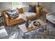 Cozy living room featuring a stylish leather sofa, patterned rug, and wooden coffee table with decorative vases at 913 Washington St, Durham, NC 27701