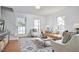 Bright living room with hardwood floors, a patterned rug, and an abundance of natural light at 913 Washington St, Durham, NC 27701