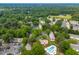 Community aerial view with pools, parking and tree lined streets and green spaces at 919 Lexington Ct, Cary, NC 27511