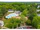 An aerial view of community pool surrounded by lush greenery and residential buildings at 919 Lexington Ct, Cary, NC 27511