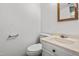 Well-lit bathroom with a toilet, vanity, and mirror creating a clean and functional space at 919 Lexington Ct, Cary, NC 27511