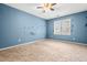 Bedroom featuring a window, carpeted floors, and a ceiling fan at 919 Lexington Ct, Cary, NC 27511