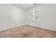 This bedroom is carpeted, has a window, and has white walls at 919 Lexington Ct, Cary, NC 27511