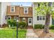 Charming townhome with brick and siding exterior and well-manicured landscaping in a vibrant community at 919 Lexington Ct, Cary, NC 27511
