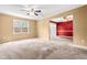 Bright living room featuring carpet flooring, ceiling fan, and an open layout for flexible living spaces at 919 Lexington Ct, Cary, NC 27511
