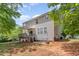 Back exterior featuring a two-story home with a deck and patio in a lush, partially shaded yard at 100 Full Moon Ct, Garner, NC 27529