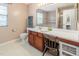 Functional bathroom featuring a long vanity with countertop and a well-lit mirror at 100 Full Moon Ct, Garner, NC 27529