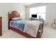 This bedroom features a wooden bed frame and a functional desk area with natural light at 100 Full Moon Ct, Garner, NC 27529