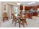 Open dining area with wood table and chairs, with kitchen in the background at 100 Full Moon Ct, Garner, NC 27529