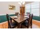 Formal dining area with hardwood floors, classic dining set, and decorative mirror at 100 Full Moon Ct, Garner, NC 27529