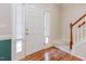 Bright entryway featuring hardwood floors, a classic staircase, and a front door with sidelights at 100 Full Moon Ct, Garner, NC 27529