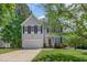 Charming two-story home with a well-manicured lawn and attached garage, complemented by mature trees at 100 Full Moon Ct, Garner, NC 27529