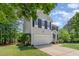 Two-story home showcasing a well-kept lawn, two-car garage, and traditional architectural details at 100 Full Moon Ct, Garner, NC 27529
