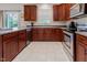 Efficient kitchen featuring dark wood cabinets, modern appliances, and ample counter space at 100 Full Moon Ct, Garner, NC 27529