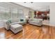 Comfortable living room featuring hardwood floors, neutral furnishings, and an open layout to the kitchen at 100 Full Moon Ct, Garner, NC 27529