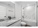 Modern bathroom features a granite vanity, white tub with marble tile, and black fixtures at 1009 Rhino Bnd, Oxford, NC 27565