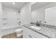 A clean bathroom with white fixtures and a granite countertop, bathtub, and a large mirror at 1009 Rhino Bnd, Oxford, NC 27565