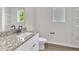 Bright bathroom featuring granite countertop, white cabinets, modern fixtures, and shelving at 1009 Rhino Bnd, Oxford, NC 27565