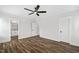 Spacious bedroom featuring wood-look floors, neutral walls, ceiling fan and multiple doors at 1009 Rhino Bnd, Oxford, NC 27565