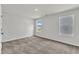 A bright empty bedroom with carpet and two windows providing natural light at 1009 Rhino Bnd, Oxford, NC 27565
